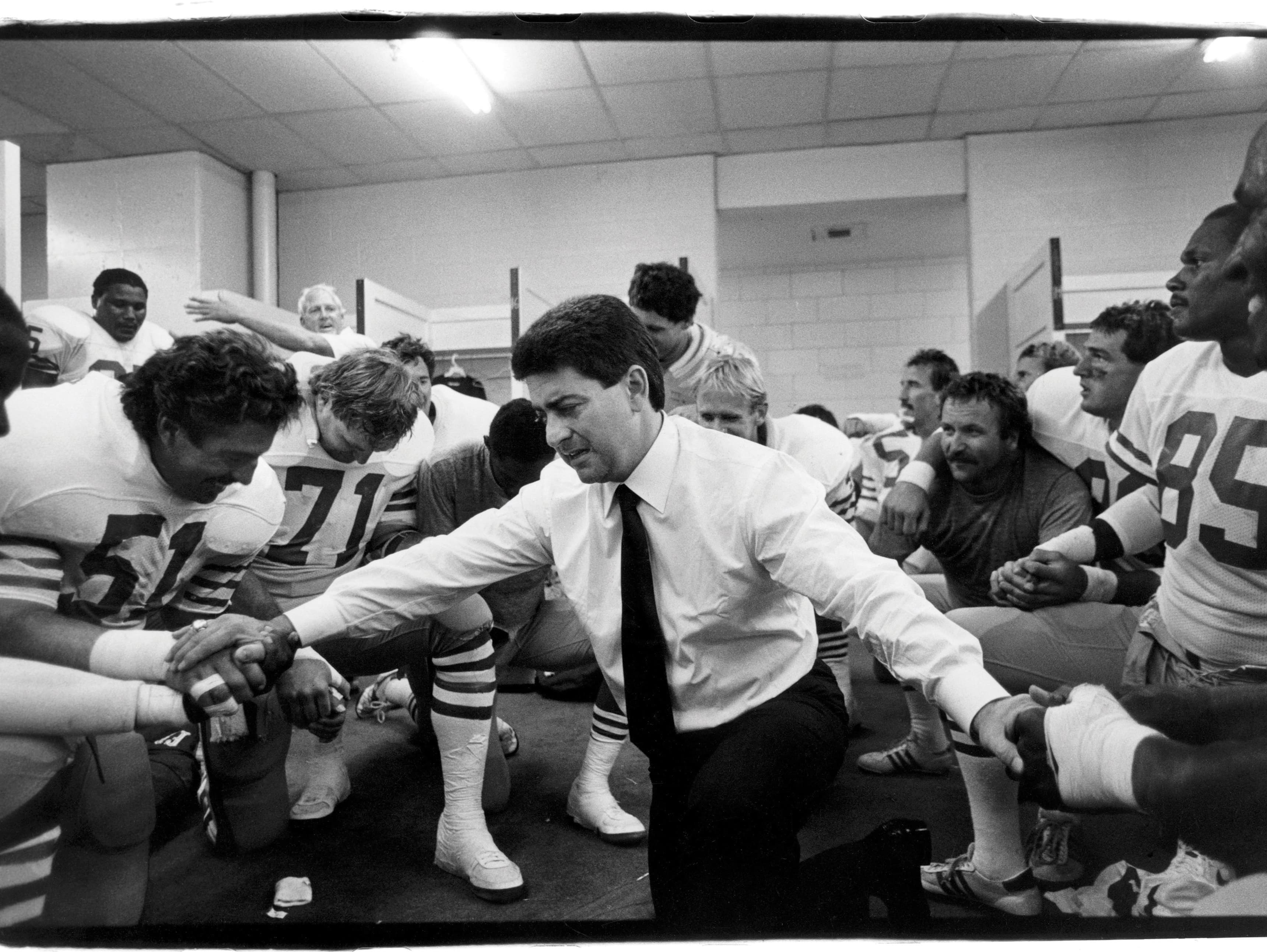 Michael Zagaris, Eddie DeBartolo Jr. prays with the team, Riverfront Stadium, 1987. Courtesy the artist.